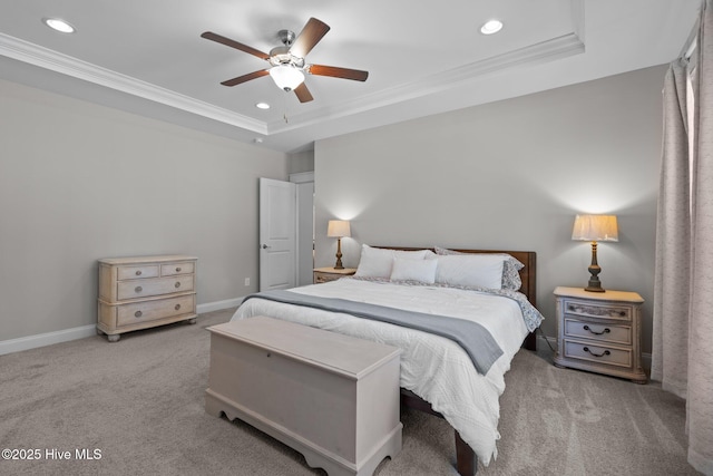 bedroom featuring carpet floors, a tray ceiling, and crown molding