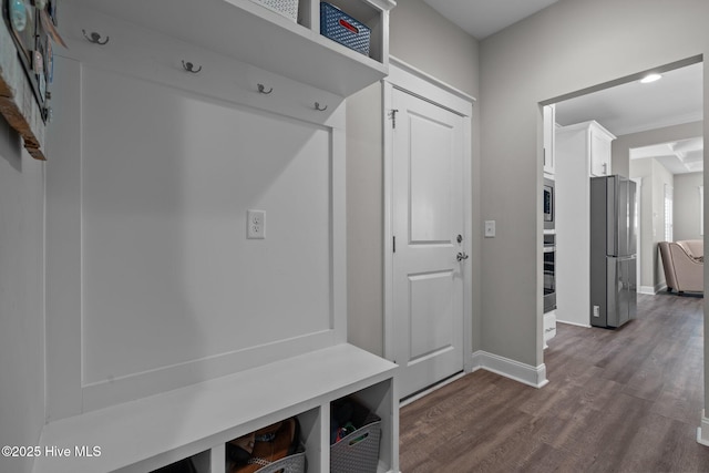 mudroom featuring baseboards and dark wood finished floors