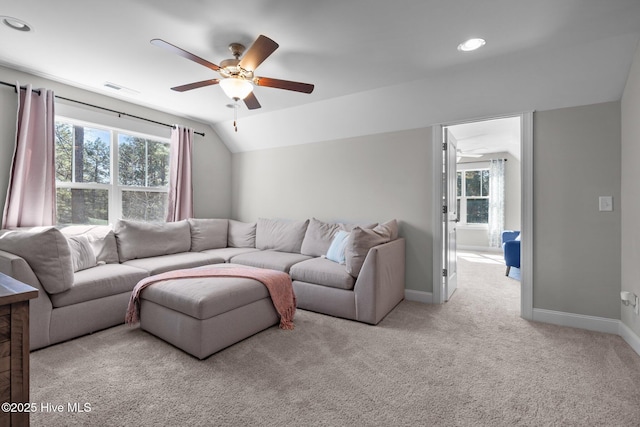 living area with carpet, visible vents, vaulted ceiling, ceiling fan, and baseboards