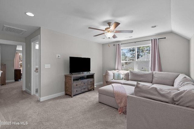 living room with lofted ceiling, light colored carpet, visible vents, ceiling fan, and baseboards