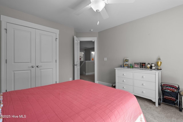 bedroom featuring carpet floors, a closet, baseboards, and a ceiling fan