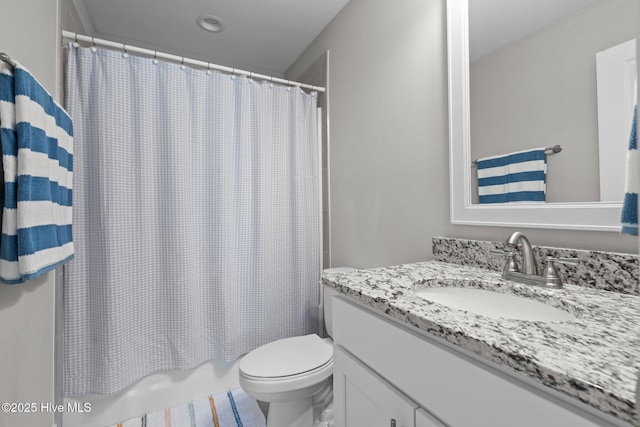 bathroom featuring shower / tub combo, vanity, and toilet