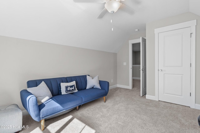 carpeted living room with a ceiling fan, vaulted ceiling, and baseboards