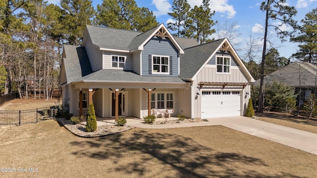 view of front of property with roof with shingles, a porch, board and batten siding, fence, and driveway