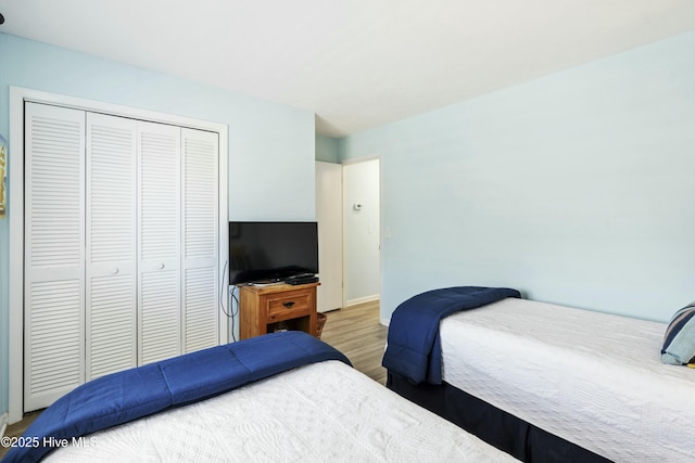 bedroom with a closet and wood finished floors