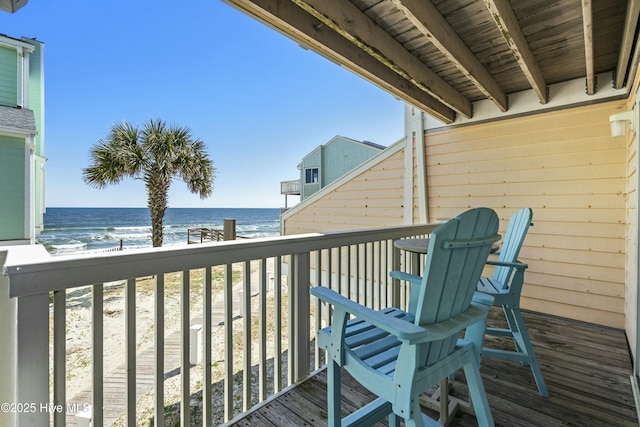 balcony with a beach view and a water view