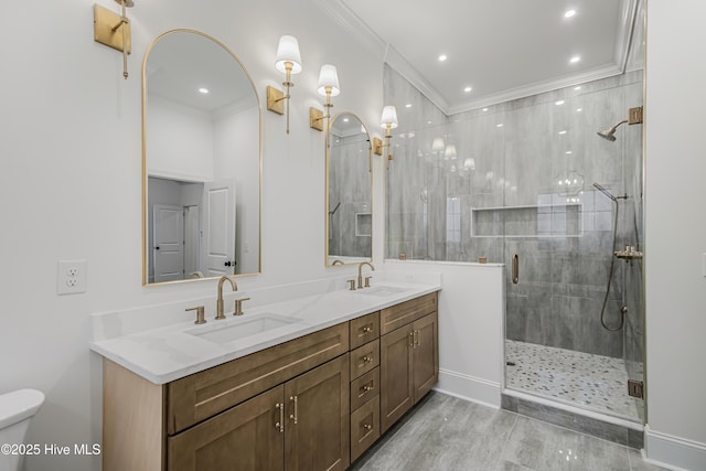 bathroom with ornamental molding, a stall shower, and a sink