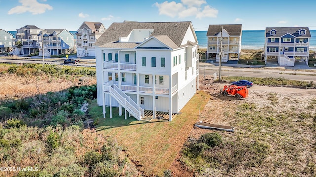 rear view of house with stairs and a residential view