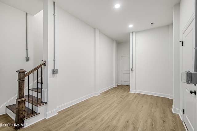 interior space with recessed lighting, baseboards, stairway, and light wood finished floors