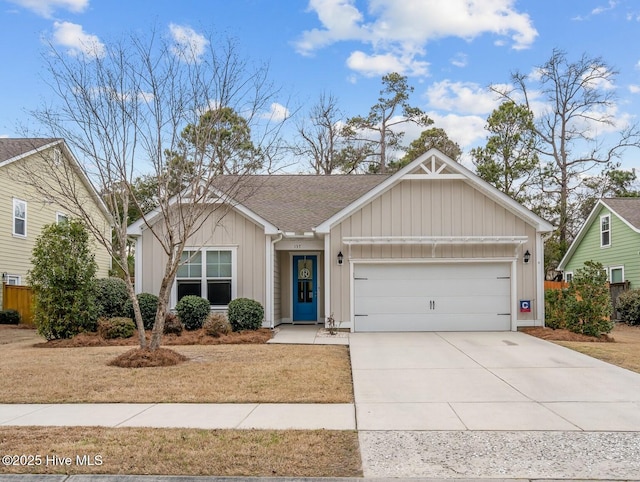 single story home with a garage, driveway, a shingled roof, and board and batten siding