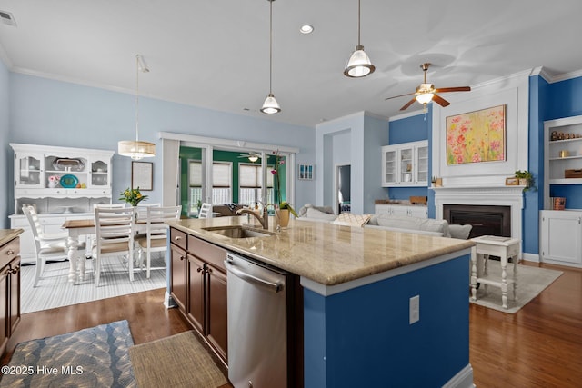 kitchen featuring dark wood-style flooring, a fireplace, stainless steel dishwasher, ornamental molding, and a sink