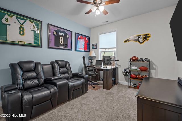 cinema room with carpet, visible vents, baseboards, and ceiling fan