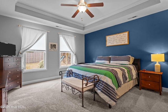 bedroom featuring crown molding, carpet, a raised ceiling, and baseboards