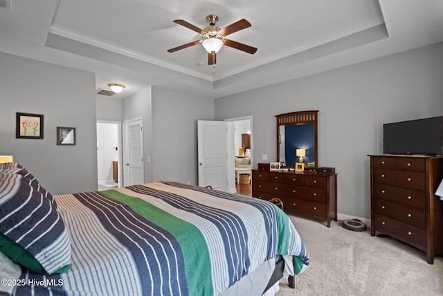 carpeted bedroom featuring ceiling fan, baseboards, and a raised ceiling