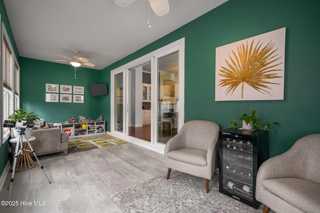 sunroom / solarium featuring ceiling fan and beverage cooler