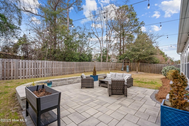 view of patio / terrace with a fenced backyard, an outdoor living space, and a playground