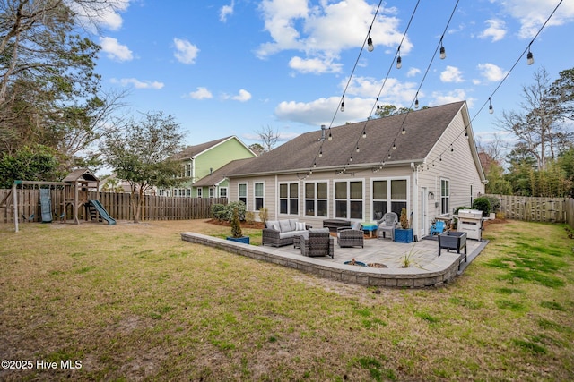 rear view of property with a patio area, a yard, an outdoor living space, and a fenced backyard