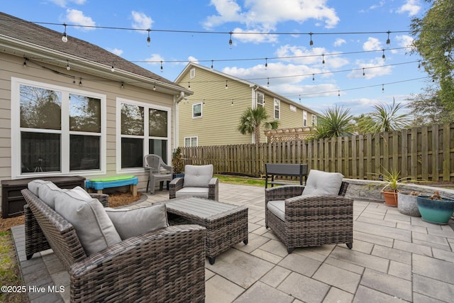 view of patio featuring fence and an outdoor hangout area