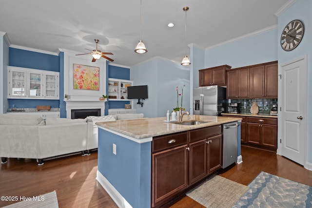 kitchen with stainless steel appliances, dark wood-style flooring, a sink, and crown molding