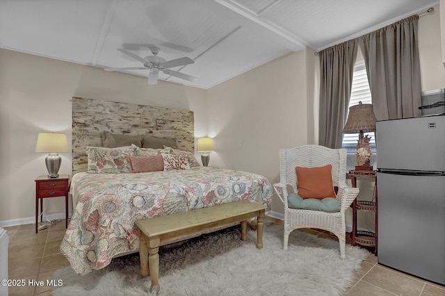 bedroom featuring tile patterned flooring, baseboards, a ceiling fan, and freestanding refrigerator