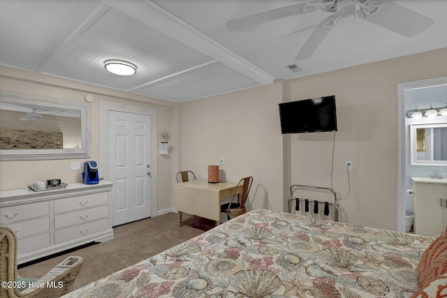 tiled bedroom with visible vents, a sink, and ensuite bathroom