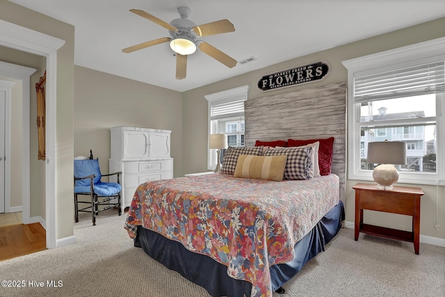 bedroom featuring carpet, baseboards, visible vents, and a ceiling fan