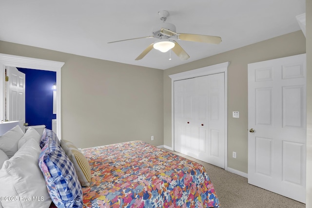 bedroom with a ceiling fan, a closet, and baseboards