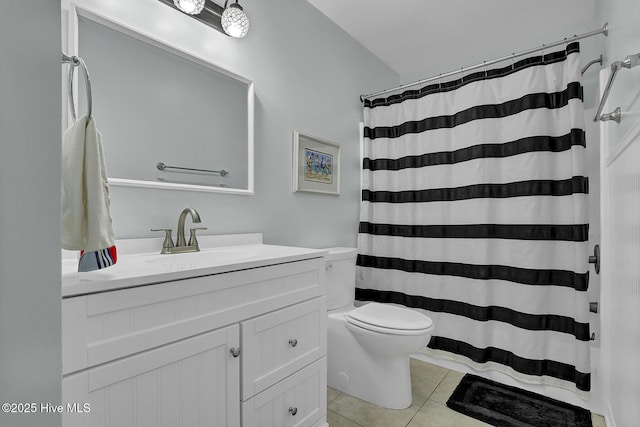 bathroom featuring toilet, curtained shower, tile patterned flooring, and vanity