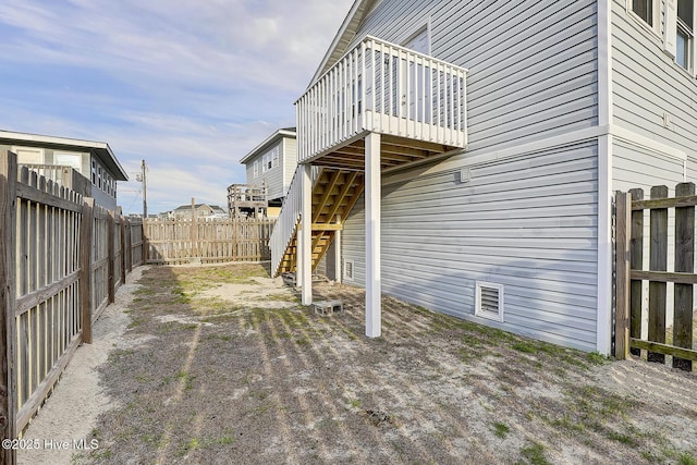 view of yard with a fenced backyard and stairs