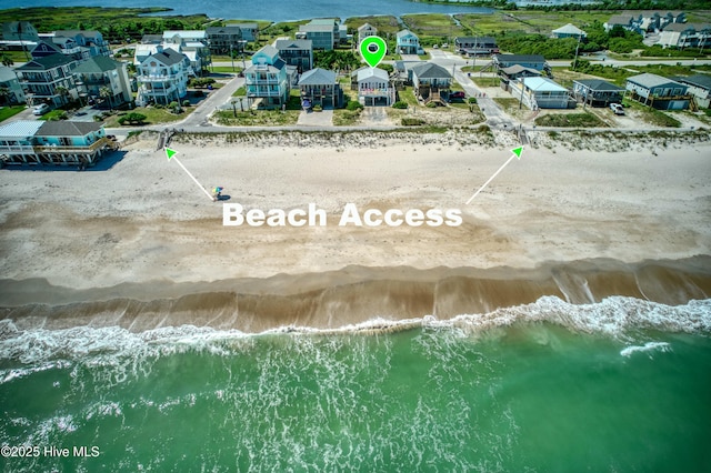 aerial view featuring a residential view, a water view, and a beach view