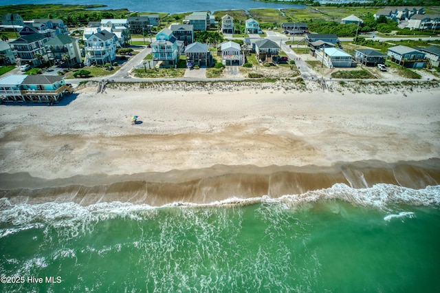 birds eye view of property with a water view, a view of the beach, and a residential view