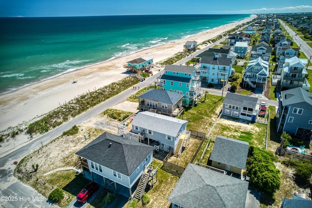 bird's eye view with a water view, a residential view, and a view of the beach