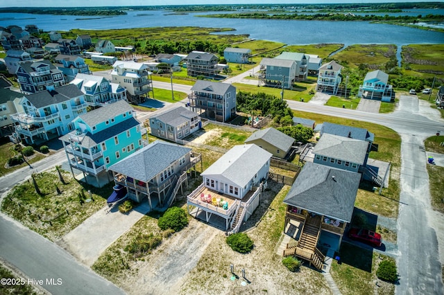 birds eye view of property with a water view and a residential view