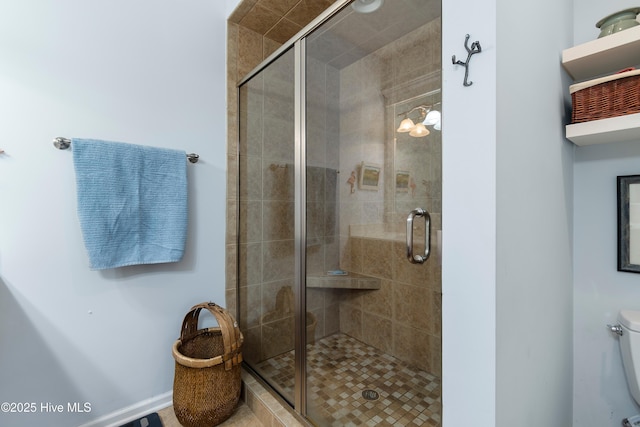 full bathroom featuring toilet and a stall shower