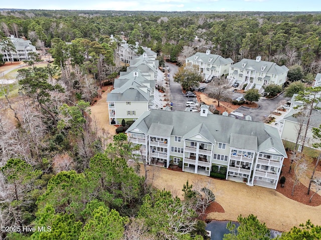 bird's eye view with a wooded view