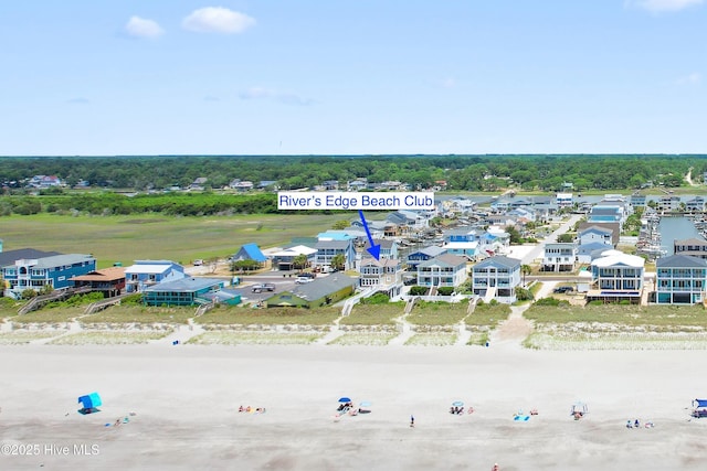 bird's eye view with a water view and a beach view