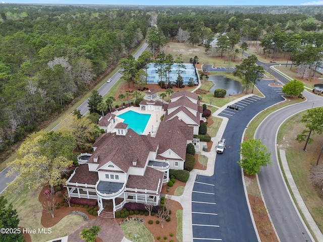 birds eye view of property with a forest view