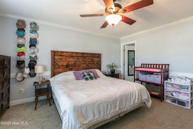 carpeted bedroom featuring baseboards, a ceiling fan, and crown molding