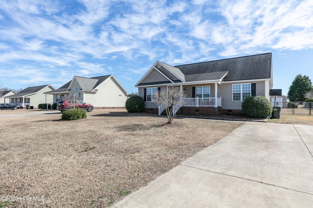 ranch-style home featuring crawl space, covered porch, and a shingled roof