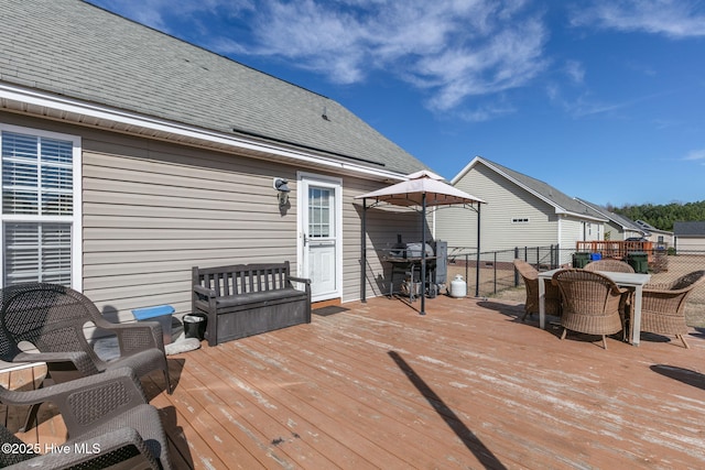 wooden deck with outdoor dining area and fence