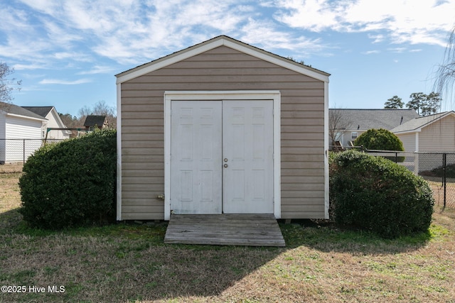 view of shed featuring fence