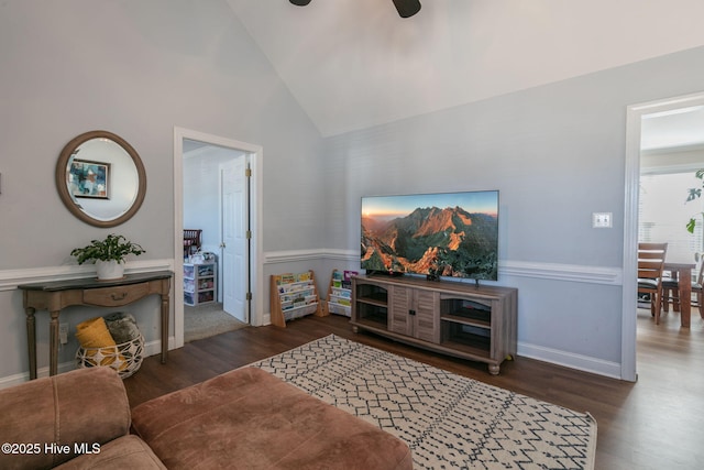 living room featuring baseboards, a ceiling fan, lofted ceiling, and wood finished floors