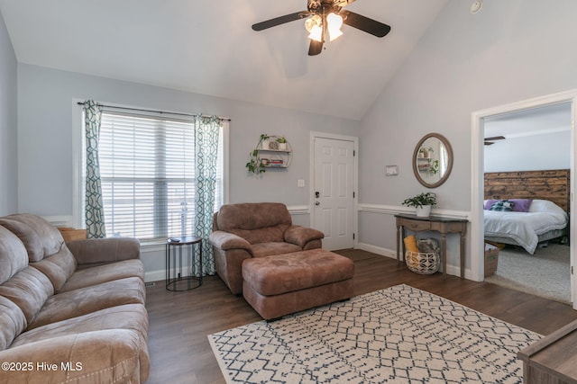 living area with high vaulted ceiling, baseboards, a ceiling fan, and wood finished floors