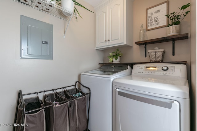 laundry room featuring electric panel, cabinet space, and washing machine and clothes dryer