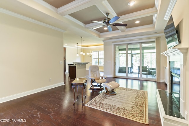 sitting room with coffered ceiling, dark wood-style floors, a high end fireplace, and ceiling fan with notable chandelier