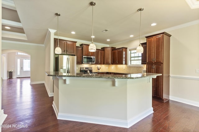 kitchen with a breakfast bar, dark stone countertops, arched walkways, stainless steel appliances, and dark wood-style flooring