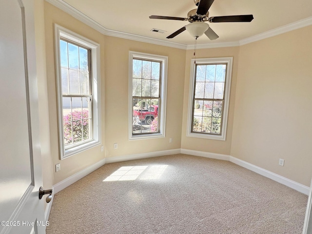 spare room featuring light carpet, crown molding, and baseboards