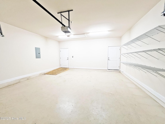 garage with electric panel, a garage door opener, and baseboards