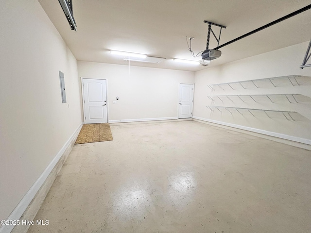 garage featuring electric panel, a garage door opener, and baseboards