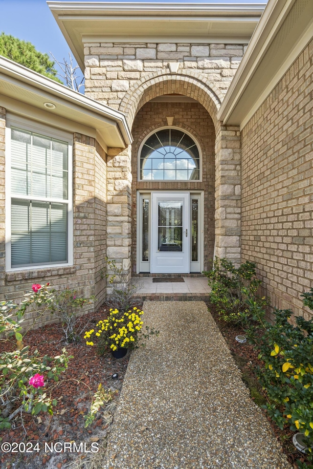 view of exterior entry featuring stone siding